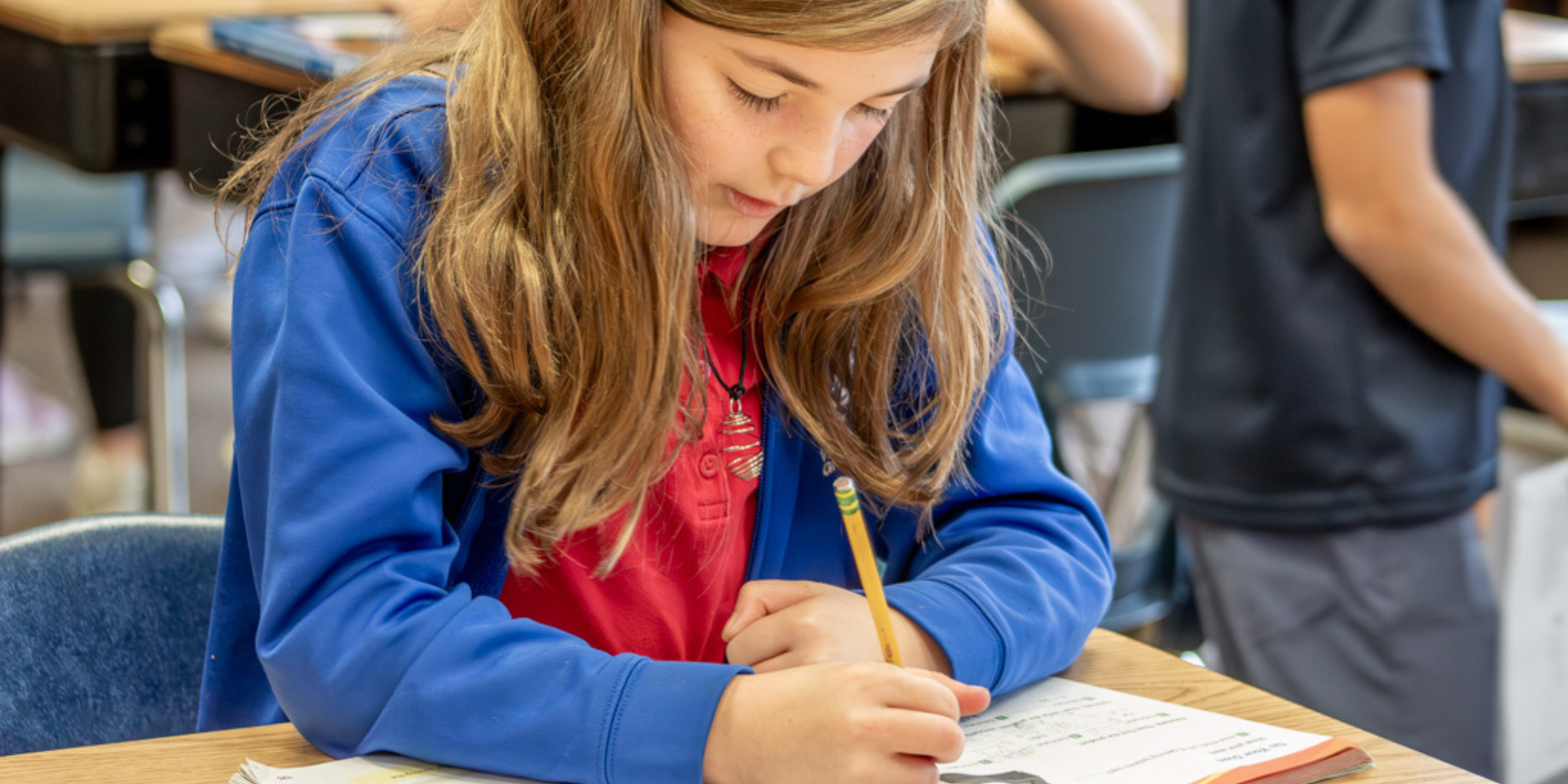 Student writing with pencil